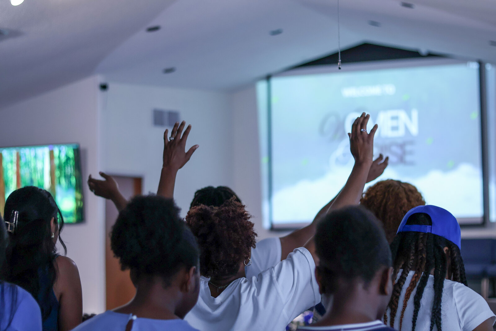 Hands raised in worship at Women's Arise
