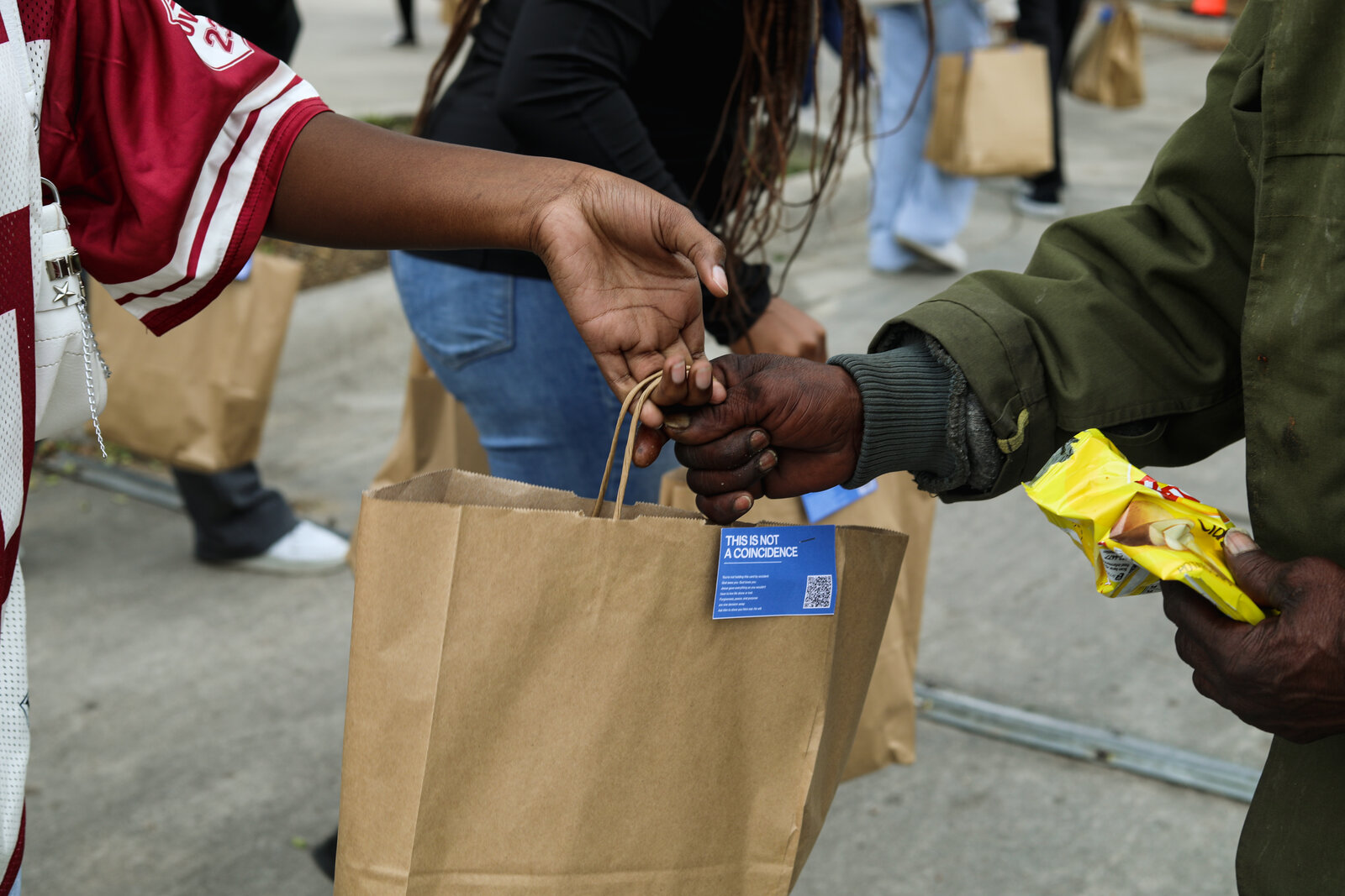 Handing off a meal bag during a Go Ye outreach